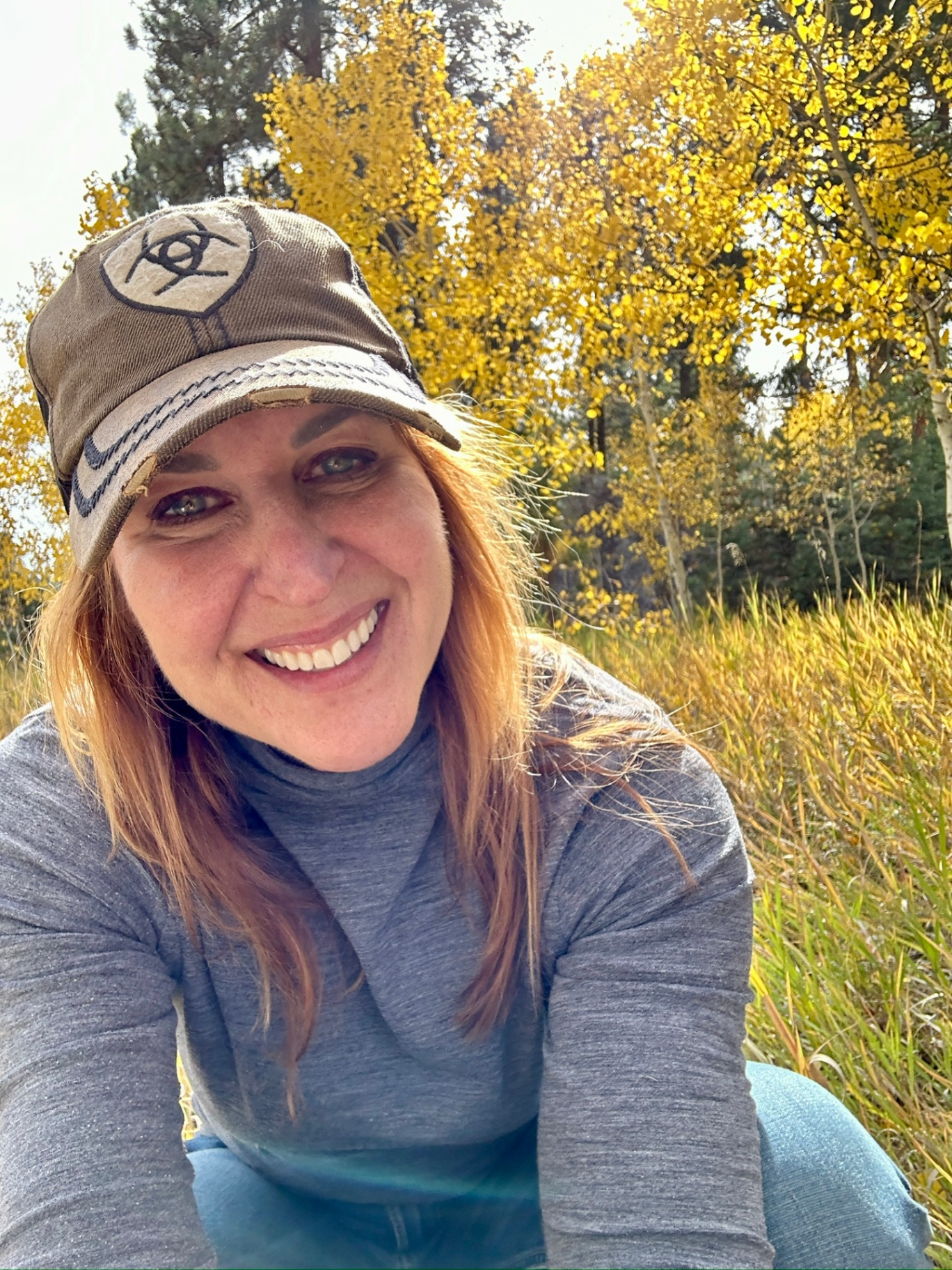 Portrait of the founder smiling outdoors with golden aspen trees in the background